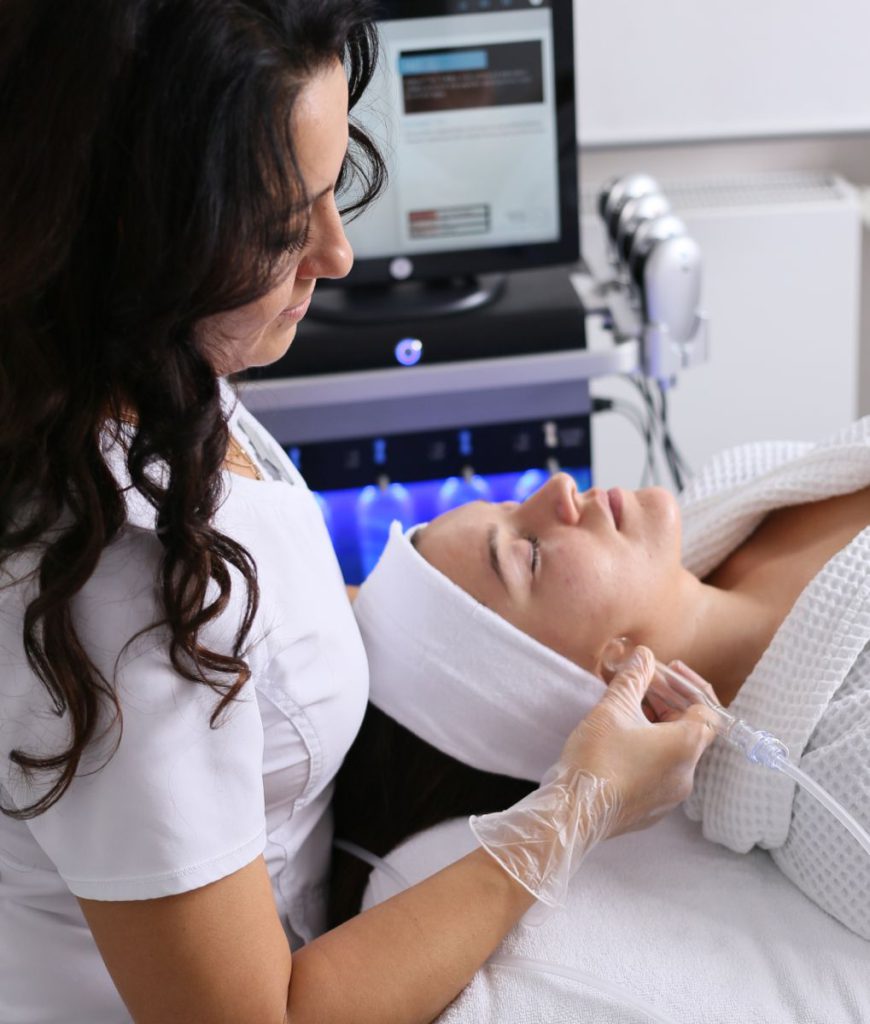 Beauty therapist during a facial at the AFACIAL studio in Vienna